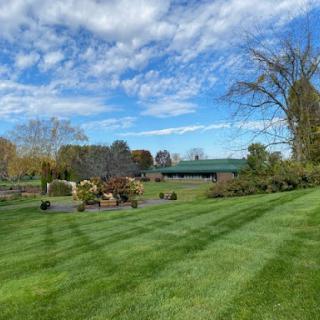 A beautiful landscape featuring a manicured garden under a bright blue sky.