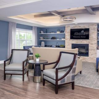 A modern living room with cozy seating, a fireplace, and stylish decor.