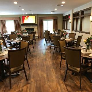 A neatly arranged dining room with tables set for a meal.