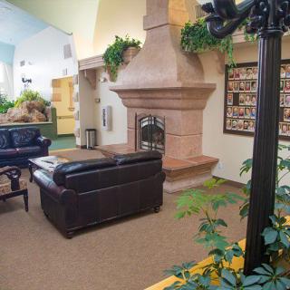 A cozy lobby with a fireplace and comfortable seating.