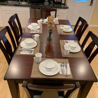 A neatly set dining table ready for a meal.