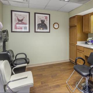 A clean and organized salon interior with chairs and wall decor.
