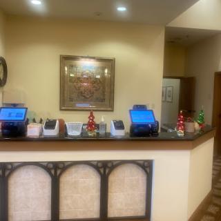 A view of a hotel reception area showcasing the checkout counter with computers and decorative elements.