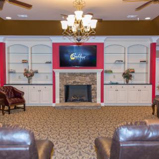 A cozy living room space featuring a fireplace, comfortable seating, and stylish decor.