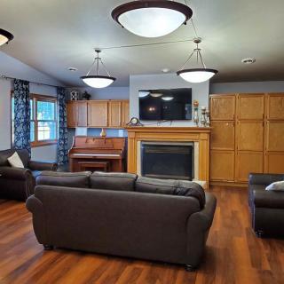 A cozy living room with stylish lighting, a fireplace, and comfortable seating.