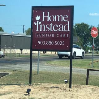 Signage for Home Instead Senior Care with contact details.