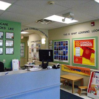 A welcoming reception area of a learning center, featuring colorful decorations and educational materials.