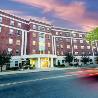 A beautifully designed hotel exterior as the sun sets, casting a warm glow.