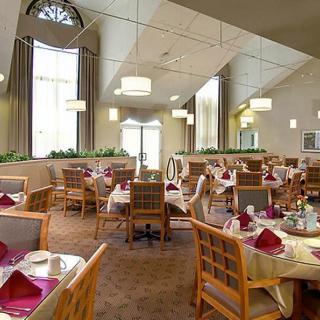 An elegant restaurant dining room with neatly arranged tables and chairs.