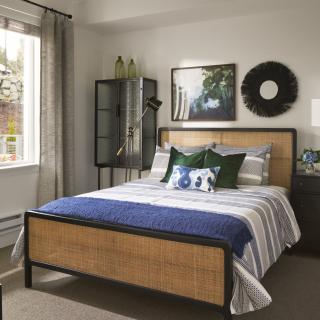 A cozy bedroom with stylish decor and a comfortable bed.