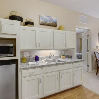 A modern kitchen with white cabinets and a dual-basin sink.