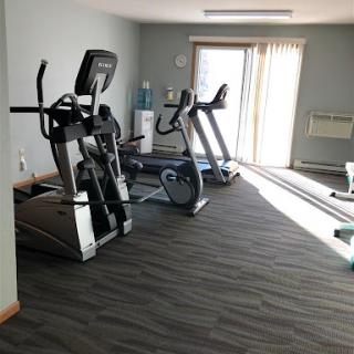 A well-equipped gym area featuring various exercise machines.