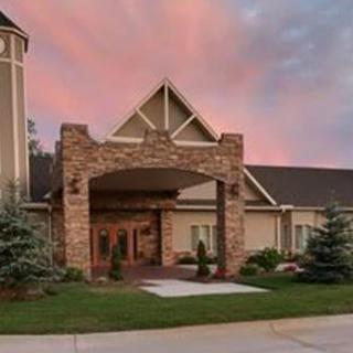 A beautifully designed building entrance with a sunset sky in the background.