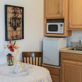 Cozy kitchen corner with a small dining table, microwave, and floral decor.