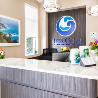 Modern reception area with a prominent logo and decorative elements.
