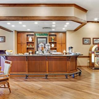 A well-lit breakfast bar featuring a buffet setup with wooden interiors and a coffee station.