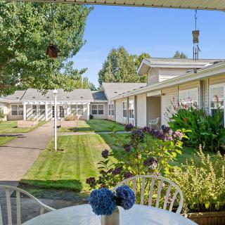 A peaceful courtyard with well-maintained gardens and outdoor seating.
