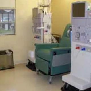 A hospital room equipped with a dialysis machine and treatment chair.