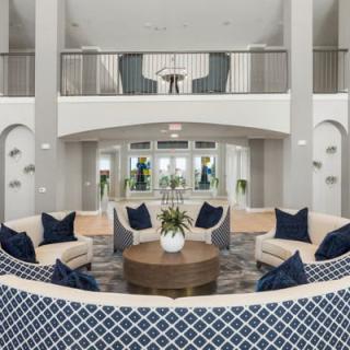 A modern living room featuring a stylish arrangement with sofas, a central coffee table, and elegant decor.