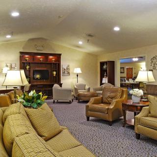 A cozy living room with comfortable seating and warm lighting.
