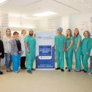 A dedicated healthcare team poses for a group photo in a hospital setting, showcasing their commitment to patient care.