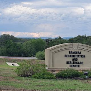 Entrance sign of the Barbera Healthcare Center surrounded by greenery.