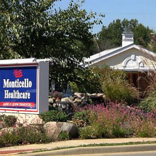 A view of Monticello Healthcare, showcasing its welcoming entrance and landscaped surroundings.