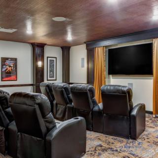 A cozy home theater with recliner seating and a large screen for an immersive viewing experience.