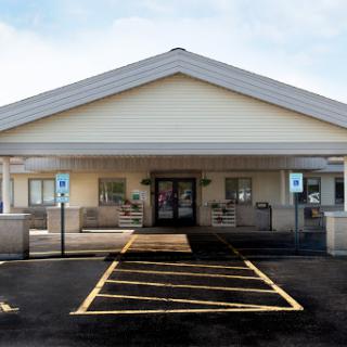 A welcoming entrance to a single-story building with accessible parking.