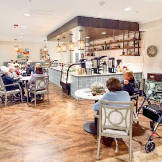 A cozy caf setting where elderly individuals gather to socialize and enjoy refreshments.