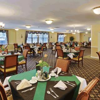 A spacious dining room with elegantly set tables and chairs.