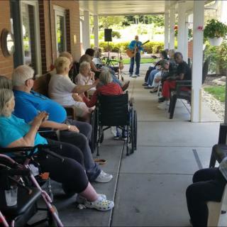 Residents enjoy a peaceful afternoon on the nursing home porch.