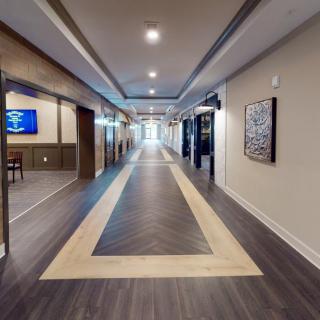 A modern hallway with wood flooring and contemporary lighting.
