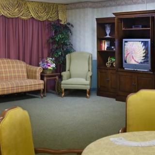 A vintage living room with classic furniture and a television.