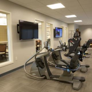 A modern gym with stationary bikes and other exercise equipment.