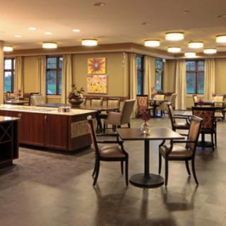 A cozy restaurant interior with tables and chairs arranged for dining.