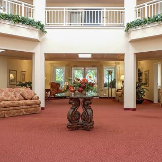 A spacious lobby area featuring elegant furniture and decorative elements.