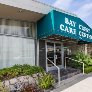 Entrance to Bay Crest Care Center with a green awning.