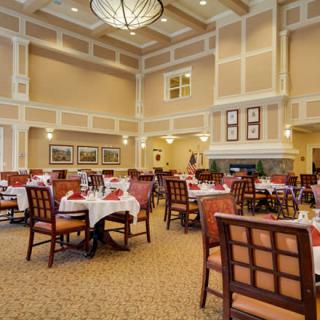 A spacious and elegantly decorated dining room with neatly arranged tables and chairs.