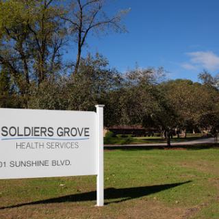Sign at Soldiers Grove Health Services on a sunny day.