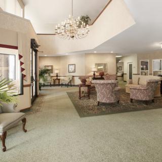 A spacious lobby with elegant furniture and a chandelier.