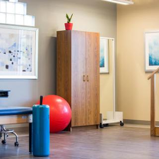 A well-designed therapy room equipped with various fitness tools for rehabilitation.