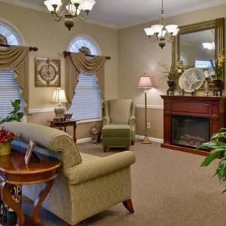 A traditional living room with elegant furnishings, including a fireplace and decorative accents.