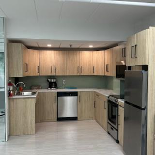 A modern kitchen featuring wooden cabinets and stainless steel appliances.