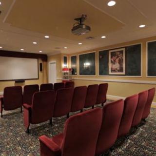A cozy home theater with comfortable seating and a large screen.