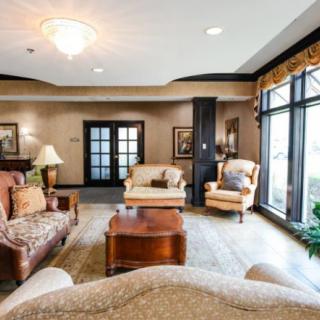 A cozy and elegantly decorated living room with comfortable seating and large windows.