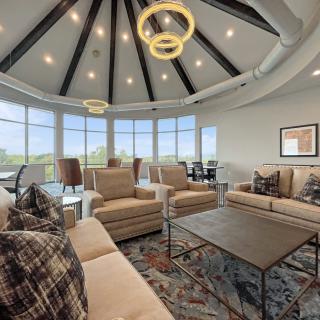 A modern living room with large windows, comfortable seating, and stylish lighting fixtures.