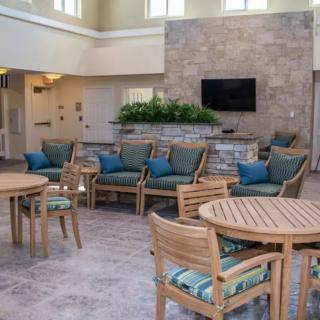 A modern lobby with comfortable seating and tables.