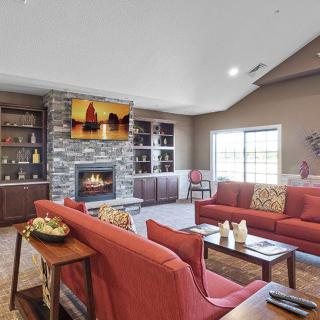 A stylish living room featuring a cozy fireplace, comfortable seating, and elegant decor.