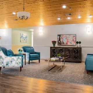 A modern living room with stylish furnishings and a wooden ceiling.